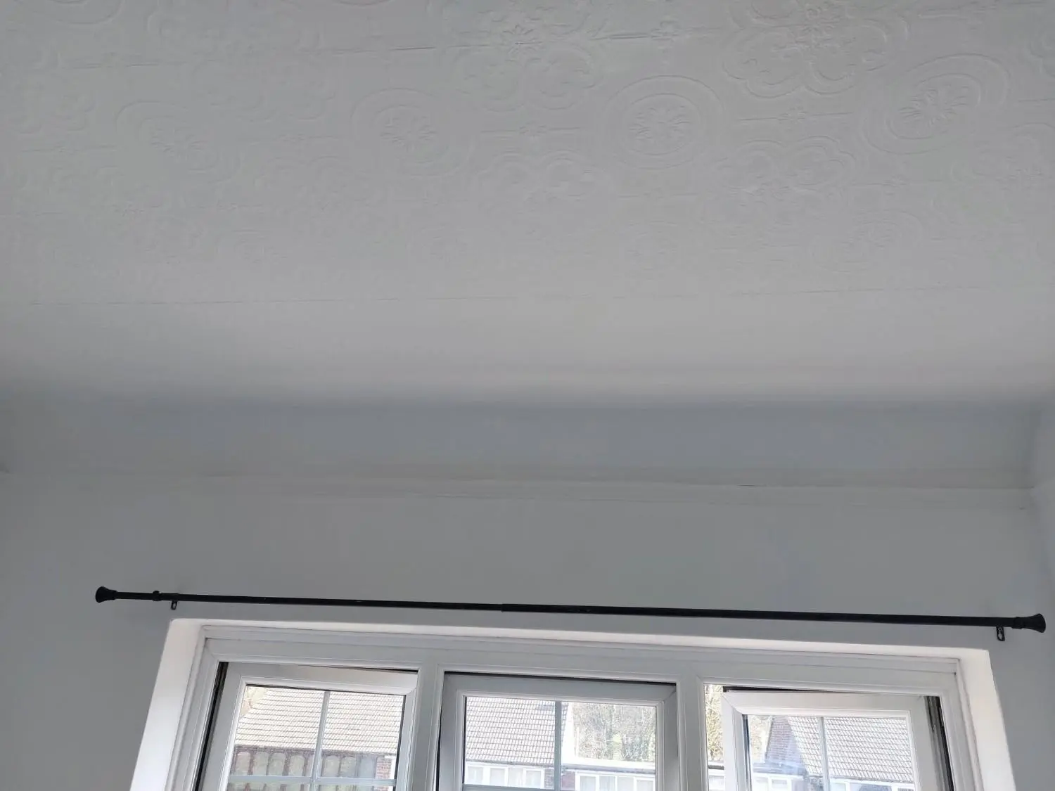 Clean ceiling and wall above a window after cleanup